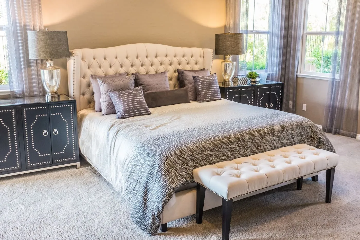 Floor-to-ceiling white linen curtains in a Hamptons bedroom with natural light flooding in